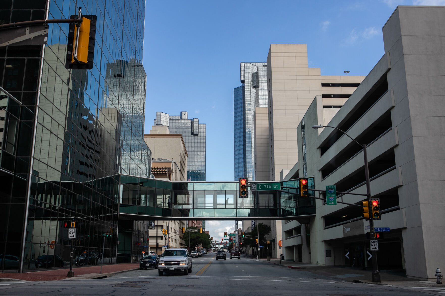 City buildings and a sky bridge linking two buildings over a street.